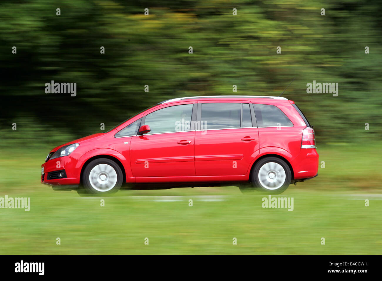 Opel Zafira 1.8 Edition , model year 2005-, red, driving, side view, country road Stock Photo