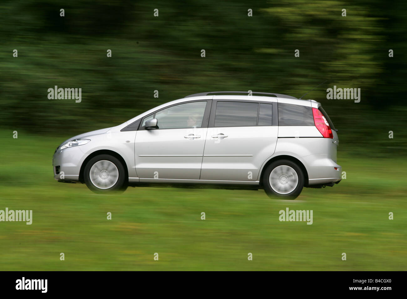 Mazda 5 2.0 MZR Top, model year 2005-, silver, driving, side view, country road Stock Photo