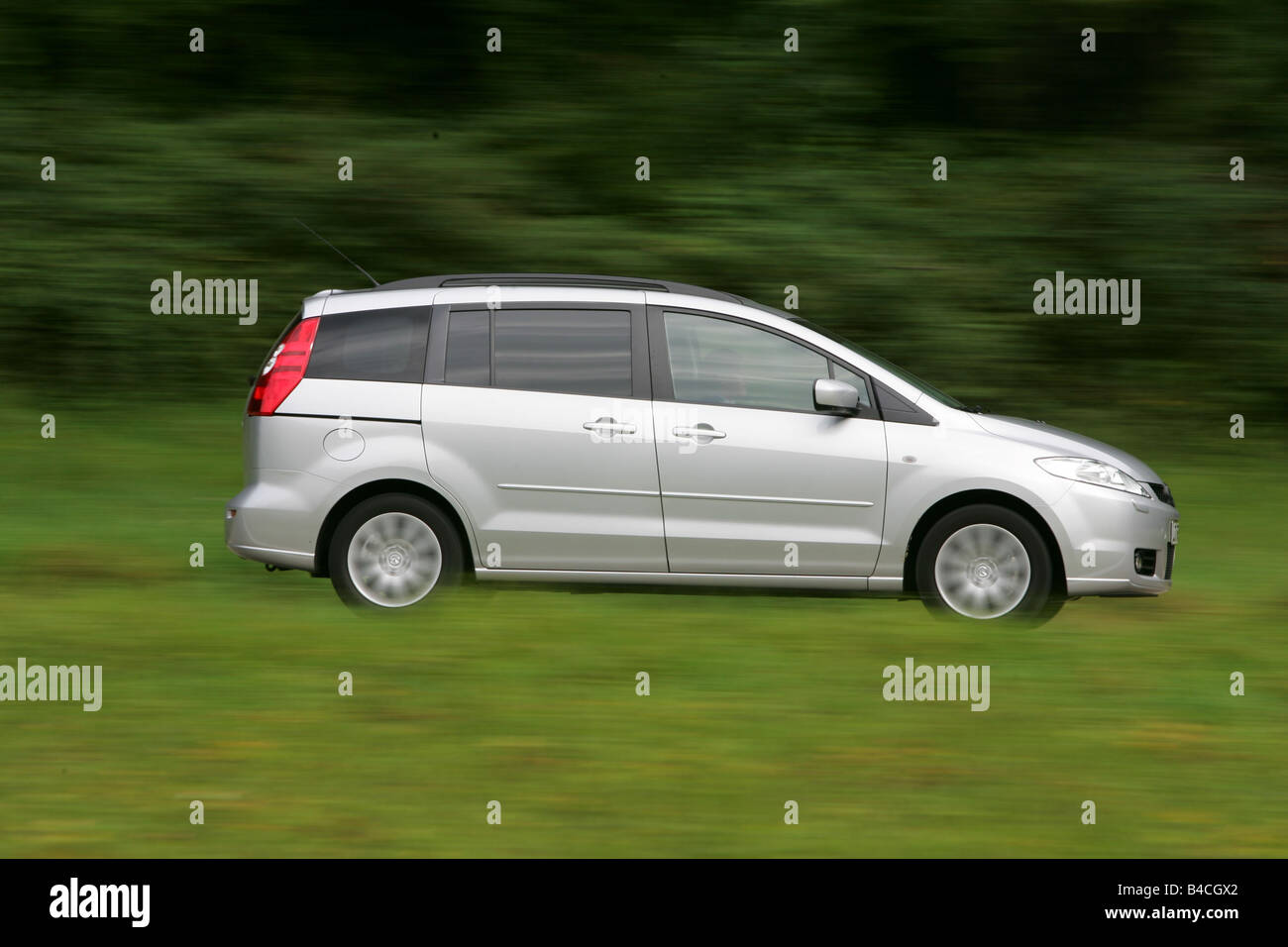 Mazda 5 2.0 MZR Top, model year 2005-, silver, driving, side view, country road Stock Photo