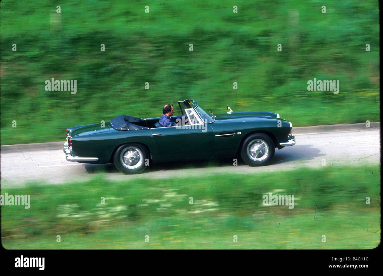 Car, Aston Martin DB4, Convertible, Vintage approx., Convertible, model year 1962-1963, green, sixties, driving, country road, s Stock Photo