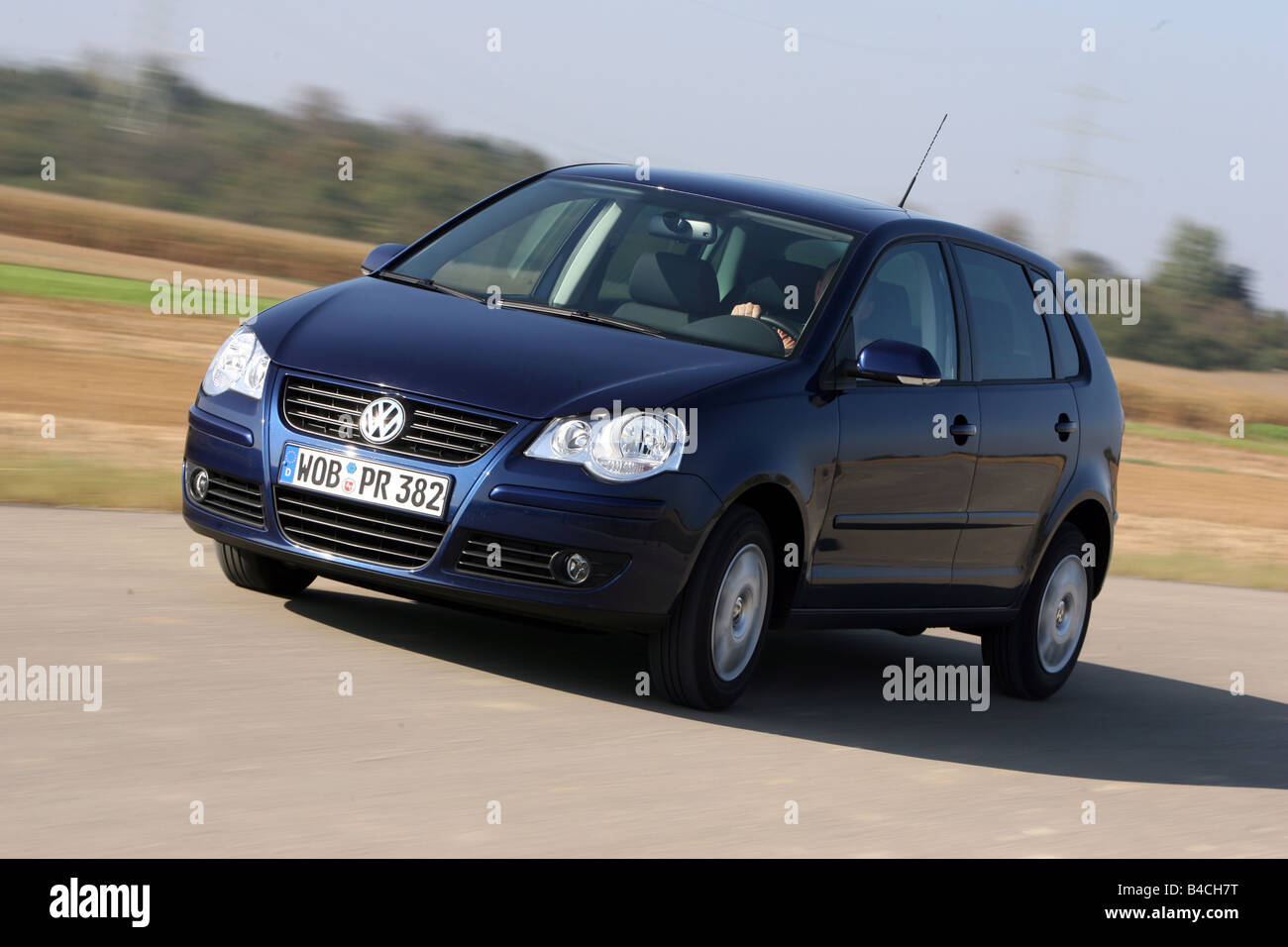 VW Volkswagen Polo 1.4 TDI, model year 2005-, dunkelblue moving, diagonal  from the front, frontal view, country road Stock Photo - Alamy