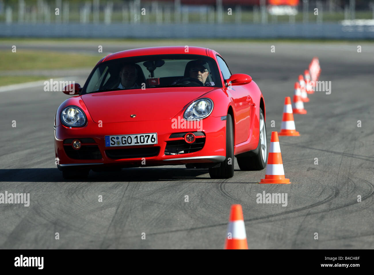 Porsche Cayman S, roadster, model year 2005-, red, driving, diagonal from the front, frontal view, test track, Pilonen Stock Photo
