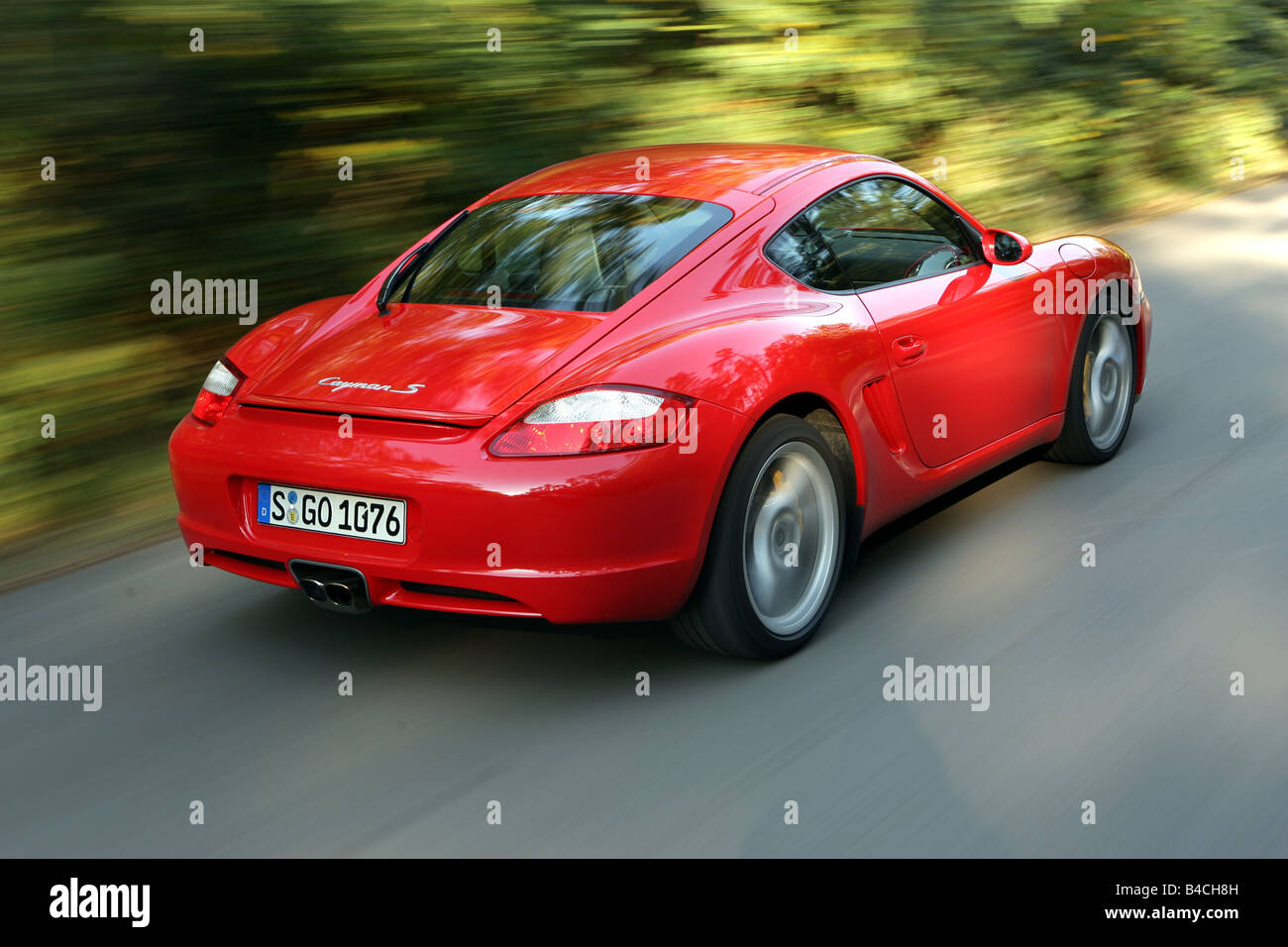 Porsche Cayman S, roadster, model year 2005-, red, driving, diagonal from the back, rear view, side view, country road, landsapp Stock Photo