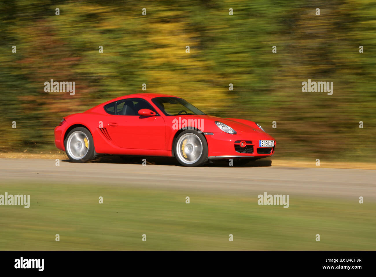 Porsche Cayman S, roadster, model year 2005-, red, driving, diagonal from the front, frontal view, side view, country road Stock Photo