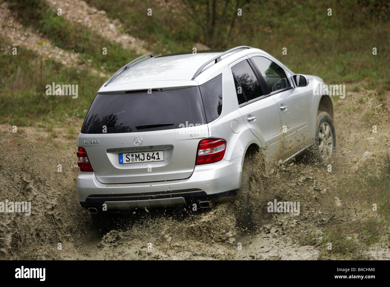 Mercedes ML 320 CDI, model year 2005-, silver, driving, diagonal from the  back, rear view, offroad, Mud, Water Stock Photo - Alamy