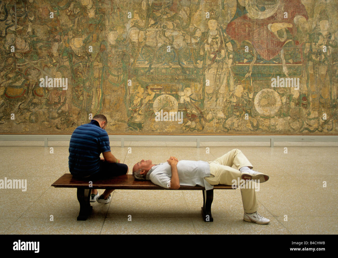 New York City Metropolitan Museum of Art two tired visitors relaxing in the Asian Art Gallery. American cultural institution in New York USA Stock Photo
