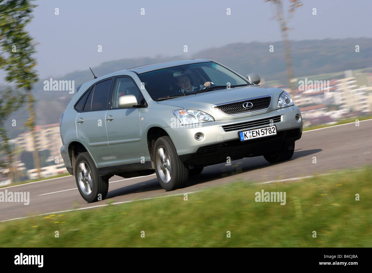 Lexus RX 400h, model year 2005-, silver, driving, diagonal from the front, frontal view, country road Stock Photo