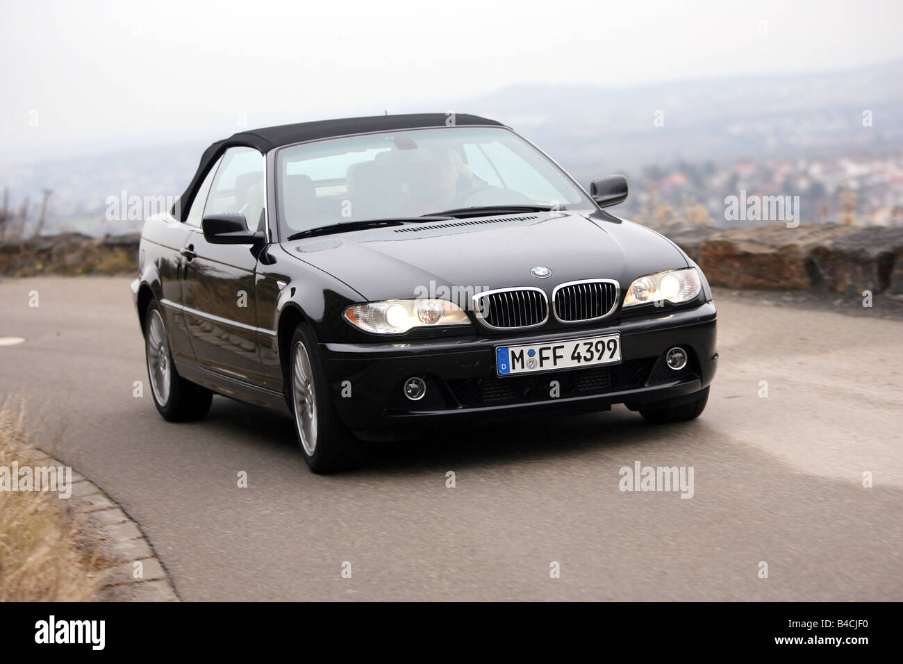 BMW 330 Cd Convertible, model year 2005-, black, driving, diagonal from the  front, frontal view, country road, closed top Stock Photo - Alamy