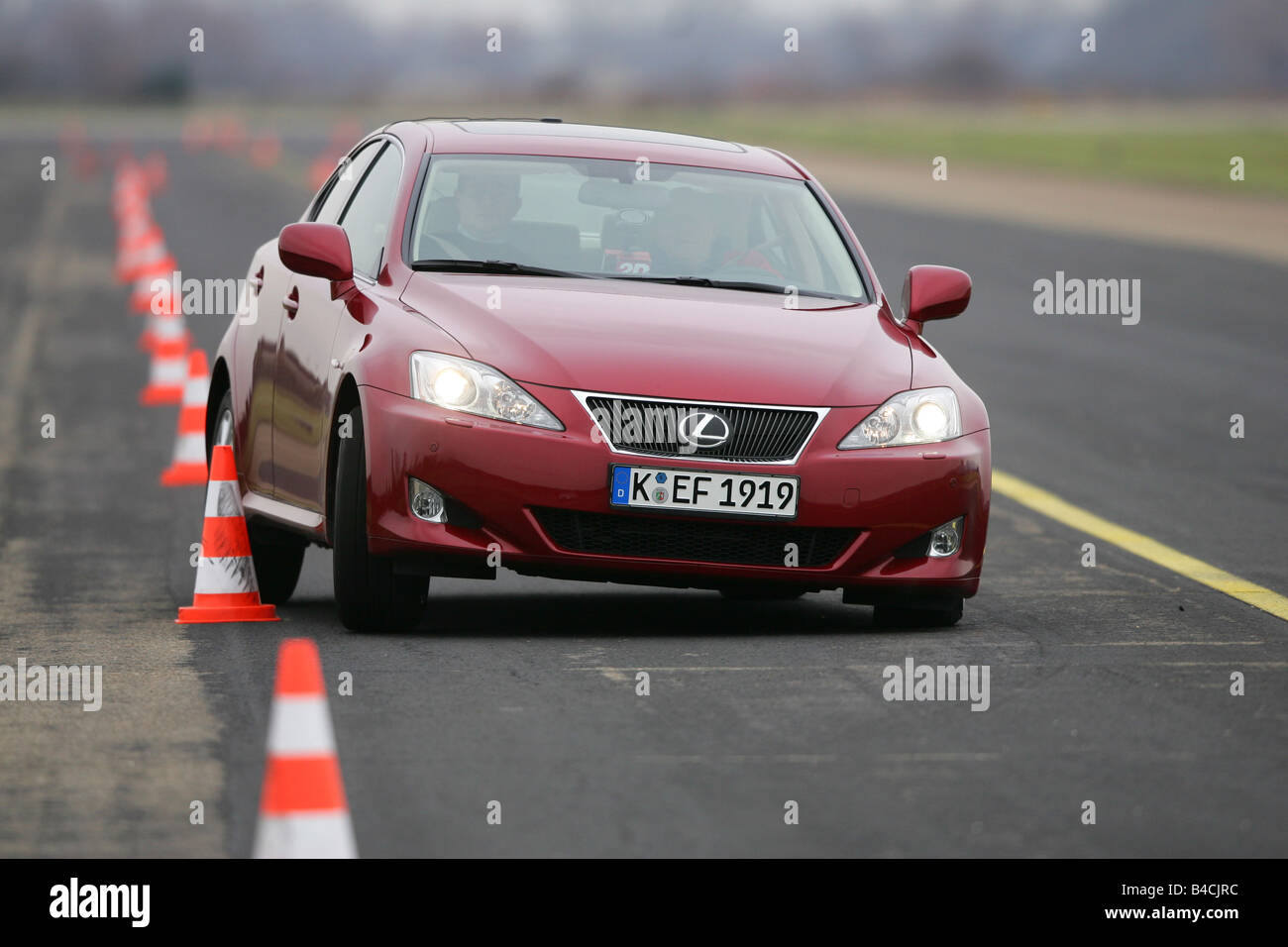 Lexus IS 250, model year 2005-, red, driving, diagonal from the front, frontal view, test track, Pilonen Stock Photo