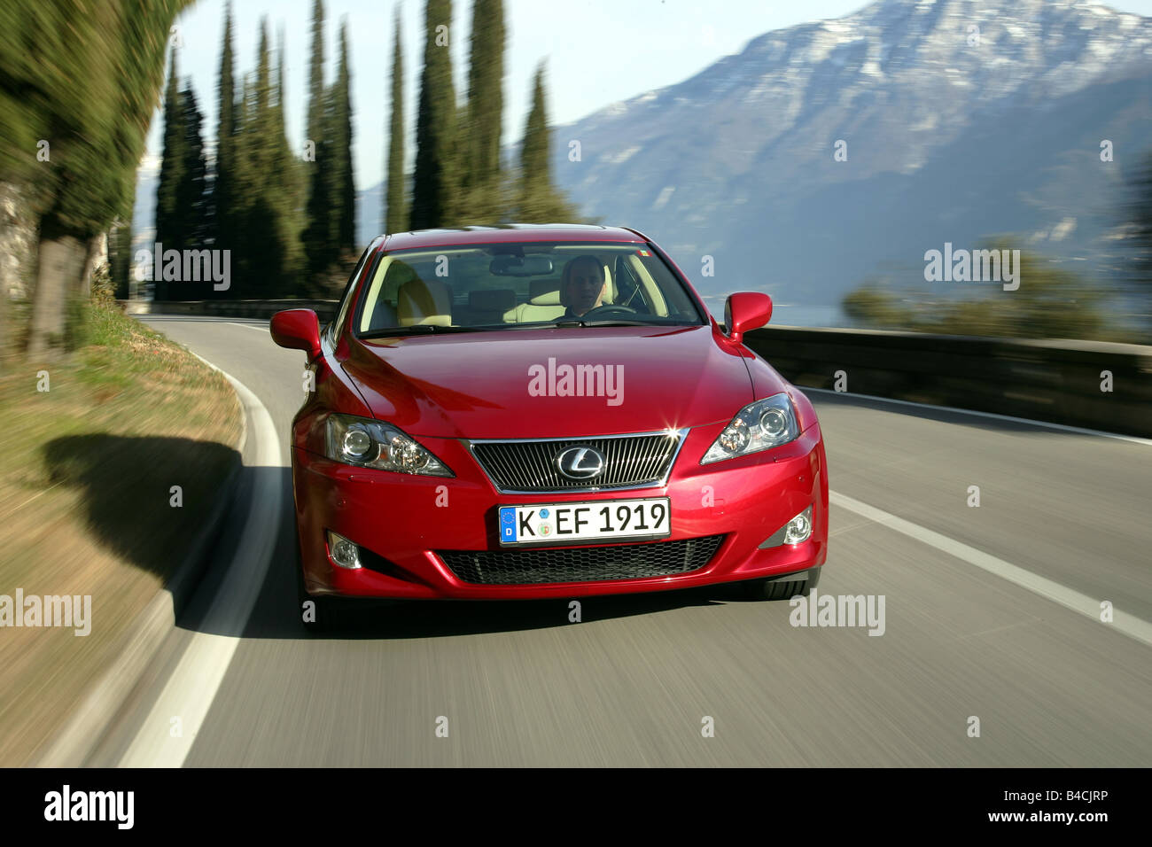 Lexus IS 250, model year 2005-, red, driving, diagonal from the front, frontal view, country road, Mountains Stock Photo