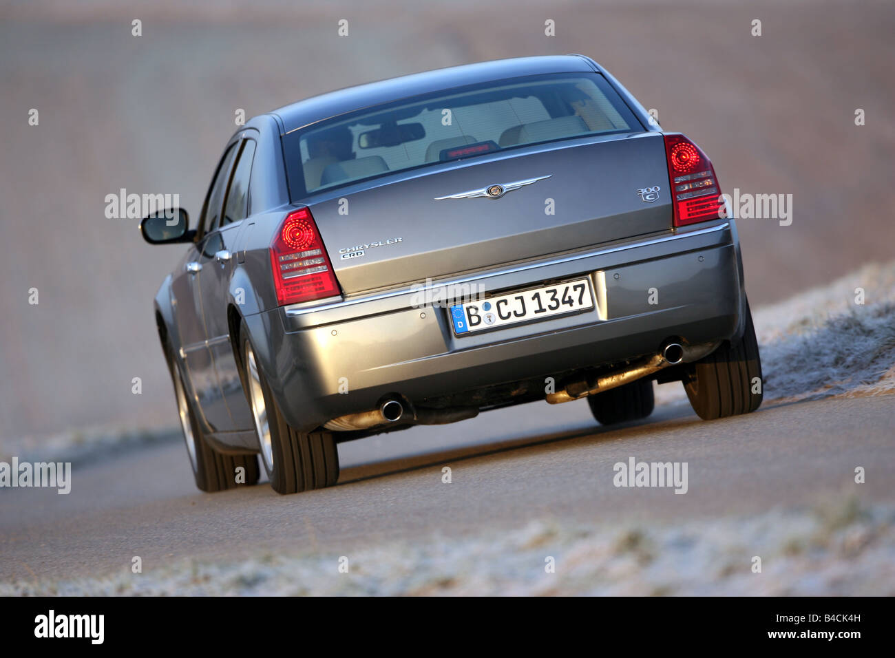 Chrysler 300 C CRD, model year 2005-, silver/anthracite, driving, diagonal from the back, rear view, country road Stock Photo