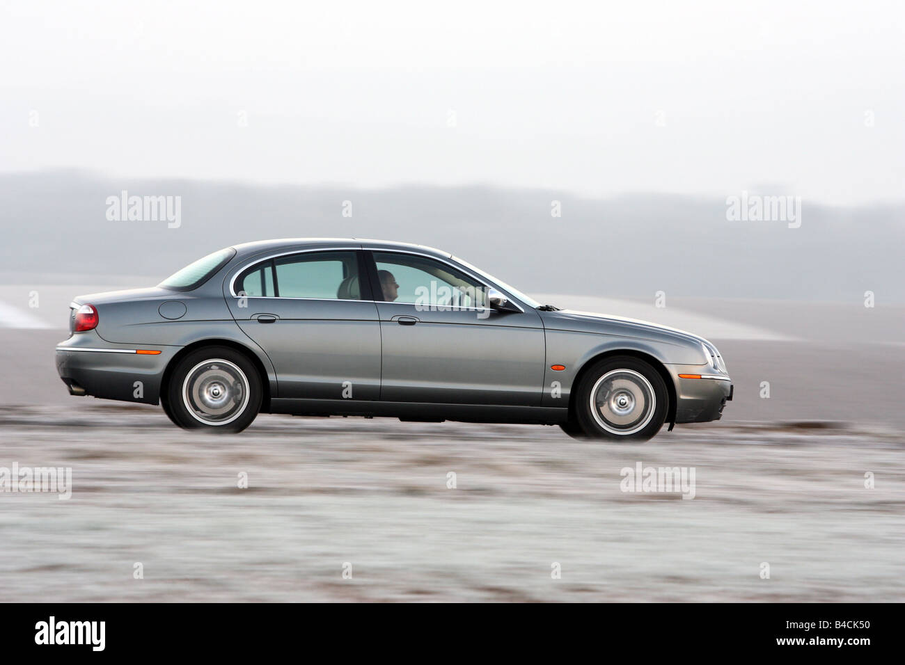 Jaguar S-Type 2.7 D, model year 2004-, silver/anthracite, driving, side view, country road Stock Photo