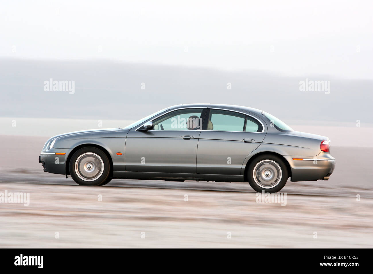 Jaguar S-Type 2.7 D, model year 2004-, silver/anthracite, driving, side view, country road Stock Photo