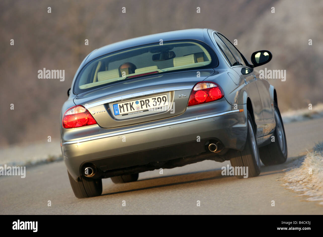 Jaguar S-Type 2.7 D, model year 2004-, silver/anthracite, driving, diagonal from the back, rear view, country road Stock Photo