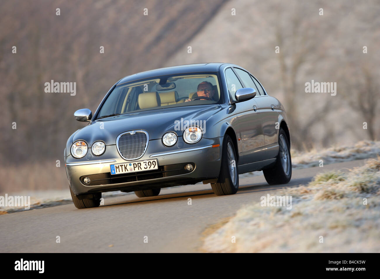Jaguar S-Type 2.7 D, model year 2004-, silver/anthracite, driving, diagonal from the front, frontal view, country road Stock Photo