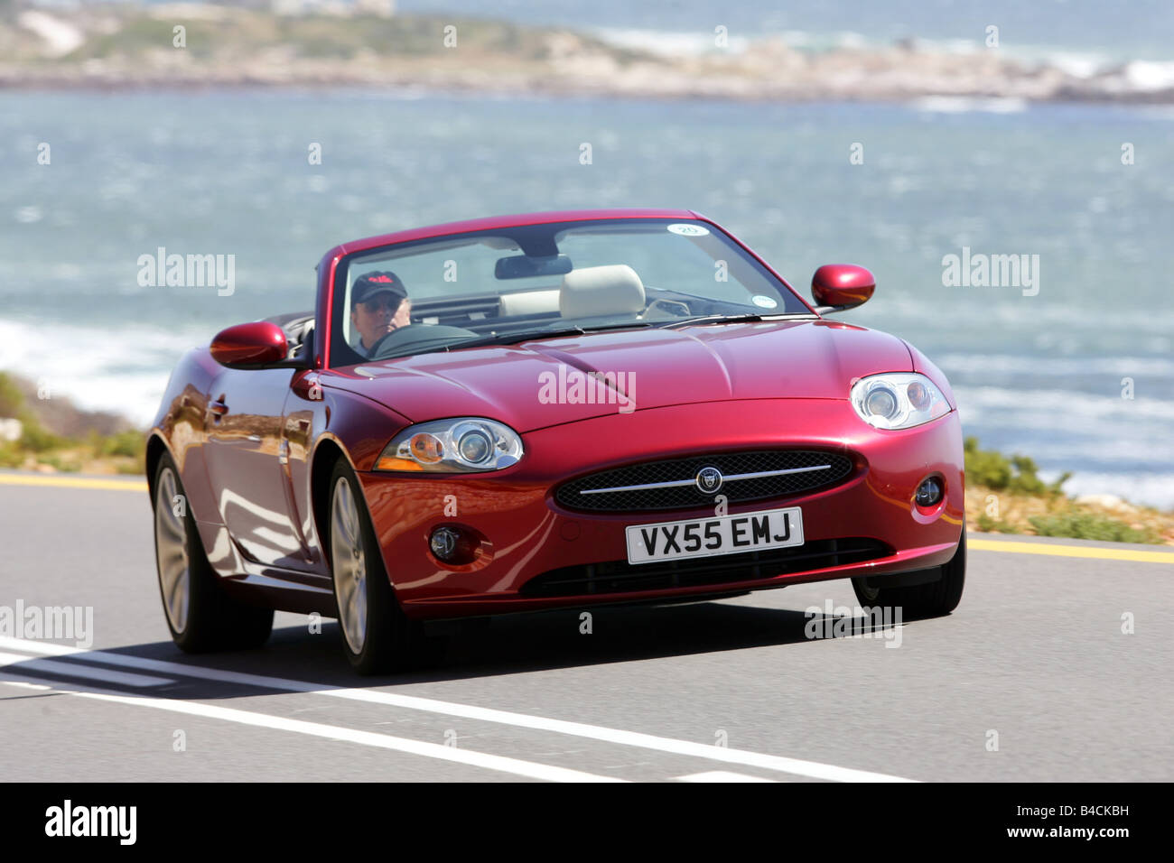Jaguar XK 4.2 V8 Convertible, model year 2006-, red, driving, diagonal from the front, frontal view, country road, landsapprox.e Stock Photo