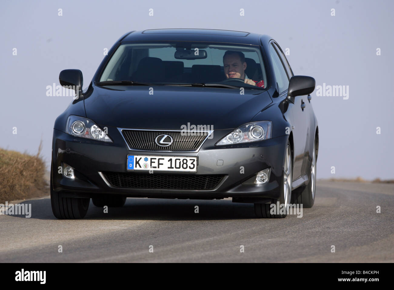 Lexus IS 250, model year 2005-, black, driving, diagonal from the front, frontal view, country road Stock Photo