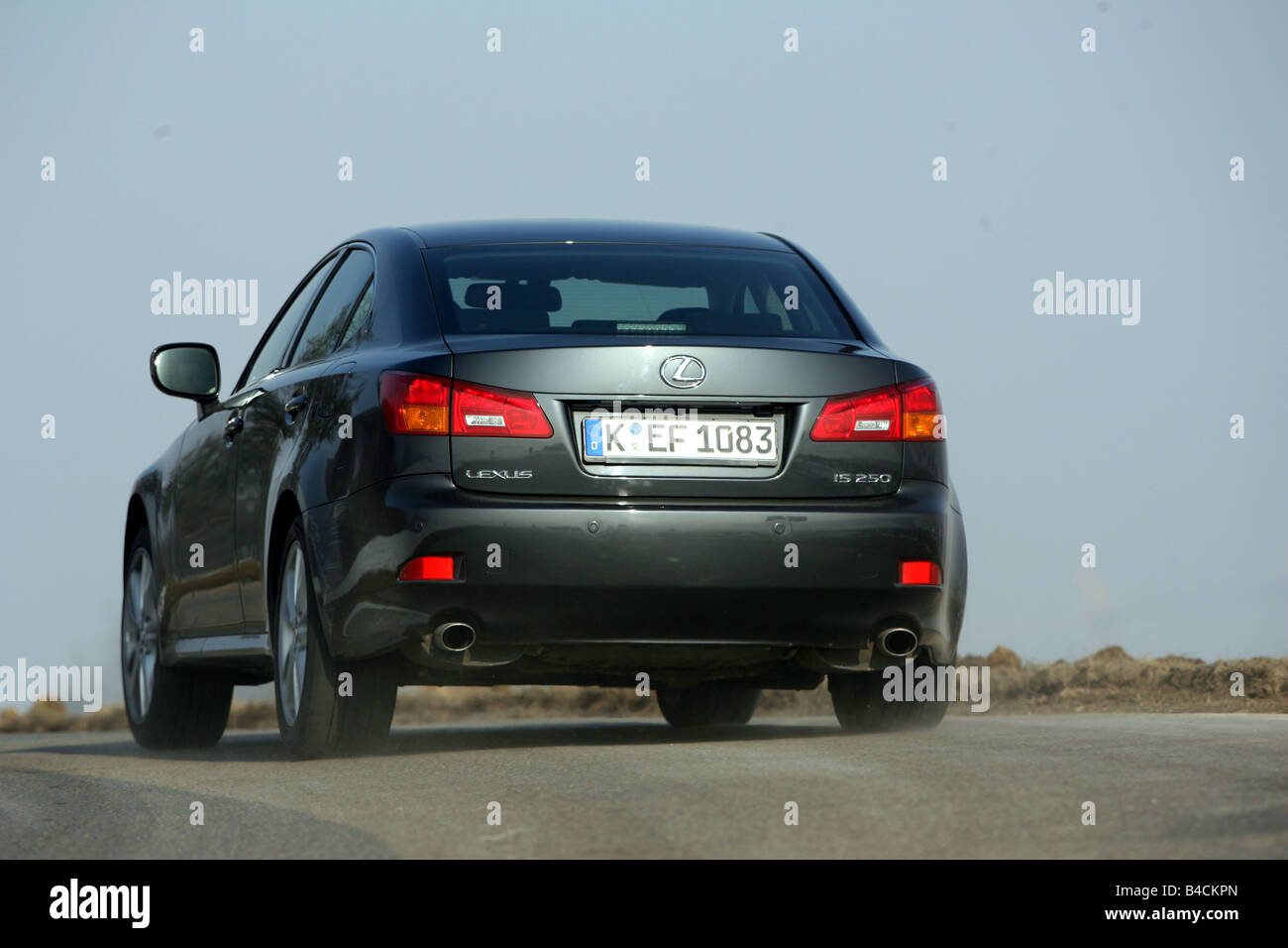 Lexus IS 250, model year 2005-, black, driving, diagonal from the back, rear view, country road Stock Photo