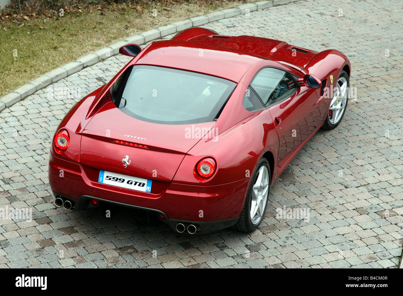 Ferrari 599 GTB Fiorano, red, model year 2006-, standing, upholding, diagonal from the back, Rear view Stock Photo