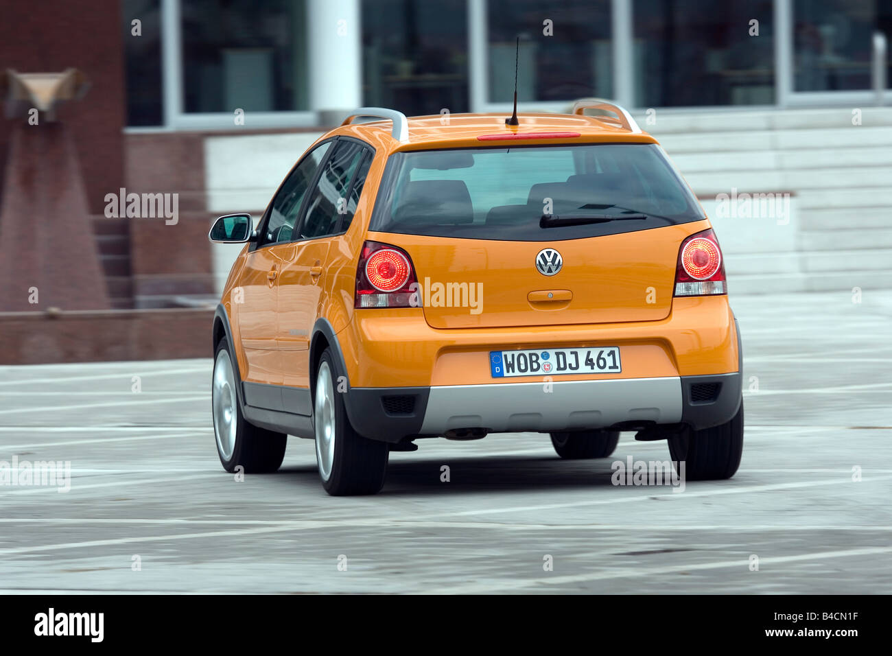 VW Volkswagen Cross Polo 1.4 TDI, model year 2006-, orange , driving,  diagonal from the back, rear view, City Stock Photo - Alamy