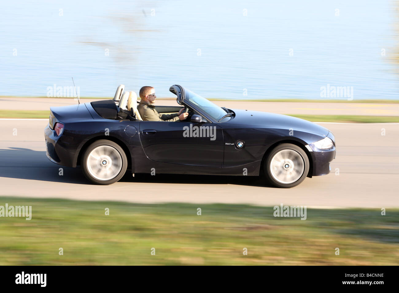 BMW Z4 3.0 si Roadster, model year 2006-, black, driving, side view, country  road, open top Stock Photo - Alamy