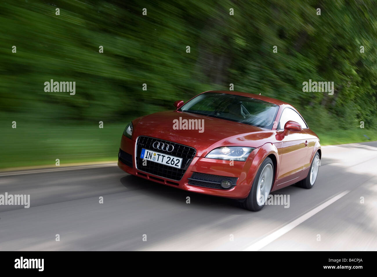 Audi TT 3.2 V6, model year 2006-, red/ruby colored, driving, diagonal from the front, frontal view, country road Stock Photo