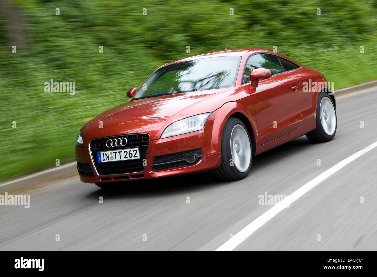 Audi TT 3.2 V6, model year 2006-, red/ruby colored, driving, diagonal from the front, frontal view, country road Stock Photo