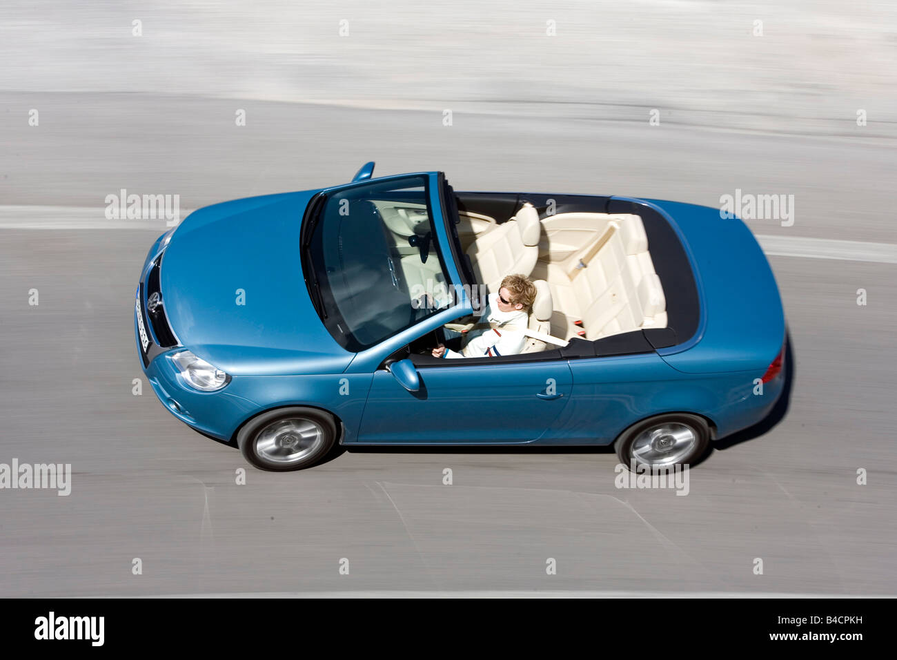 VW Volkswagen Eos 2.0 FSI, model year 2006-, hellblue moving, diagonal from above, country road, Summer, open top Stock Photo