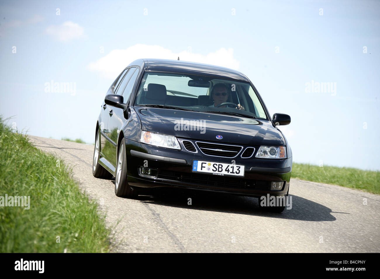 Saab 9-3 1.8t Sport Combi, model year 2006-, black, driving, diagonal from the front, frontal view, country road Stock Photo
