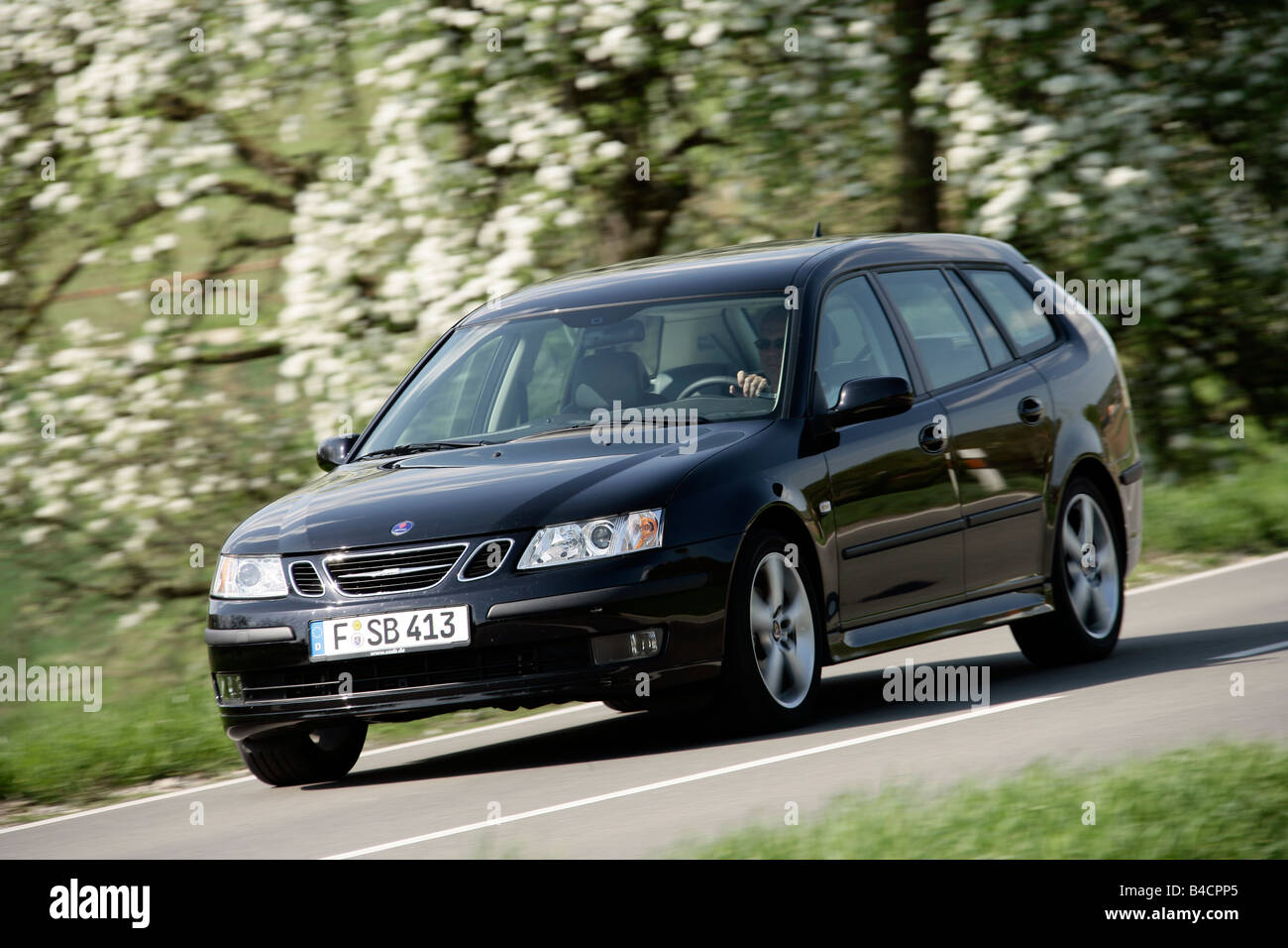 Saab 9-3 1.8t Sport Combi, model year 2006-, black, driving, diagonal from the front, frontal view, country road Stock Photo