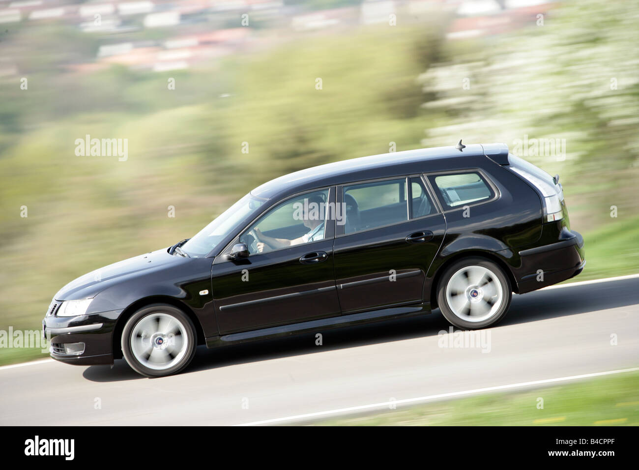 Saab 9-3 1.8t Sport Combi, model year 2006-, black, driving, side view, country road Stock Photo