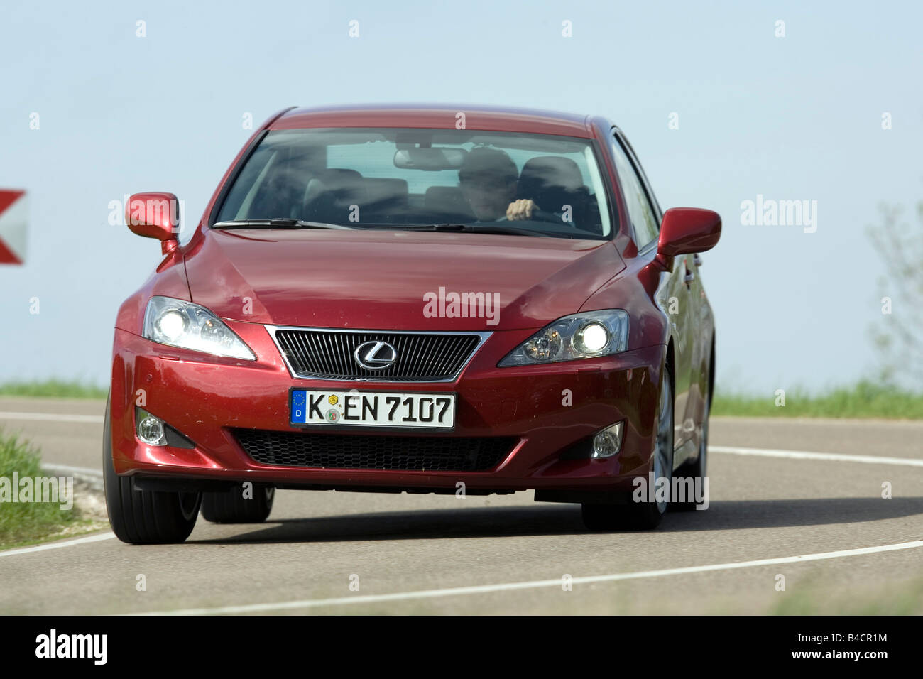 Lexus IS 220d, model year 2006, red, driving, diagonal from the front
