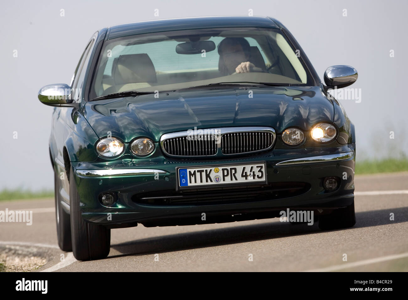 Jaguar X-Type 2.2D, model year 2006-, dark green, driving, diagonal from the front, frontal view, country road Stock Photo