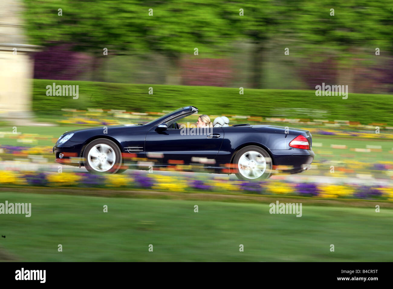 Mercedes SL 500, model year 2006-, black, open top, driving, side view, country road Stock Photo