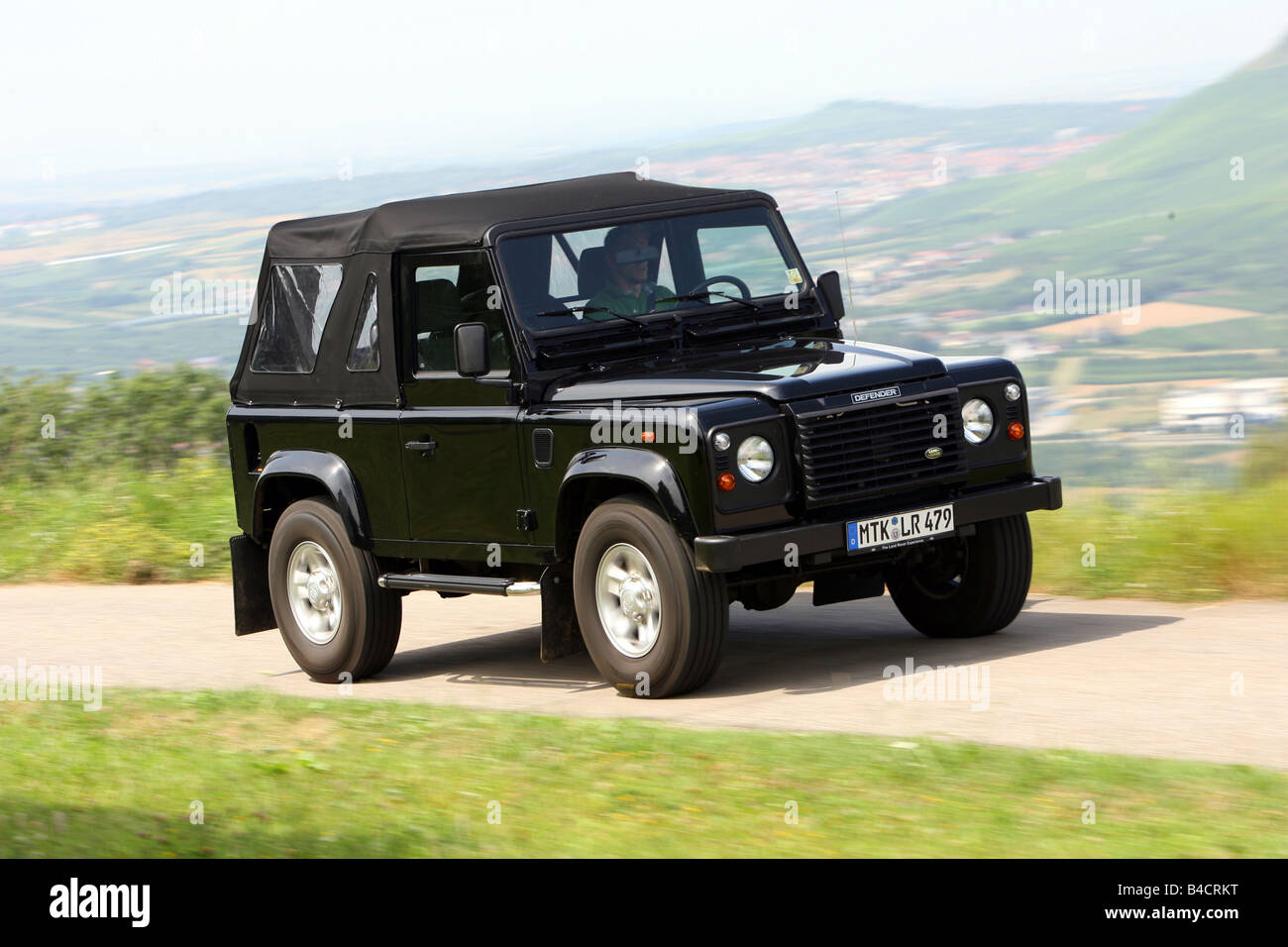 Verouderd Commandant Niet ingewikkeld Land Rover Defender Convertible Two TD5, model year 2006-, black, driving,  diagonal from the front, frontal view, country road Stock Photo - Alamy