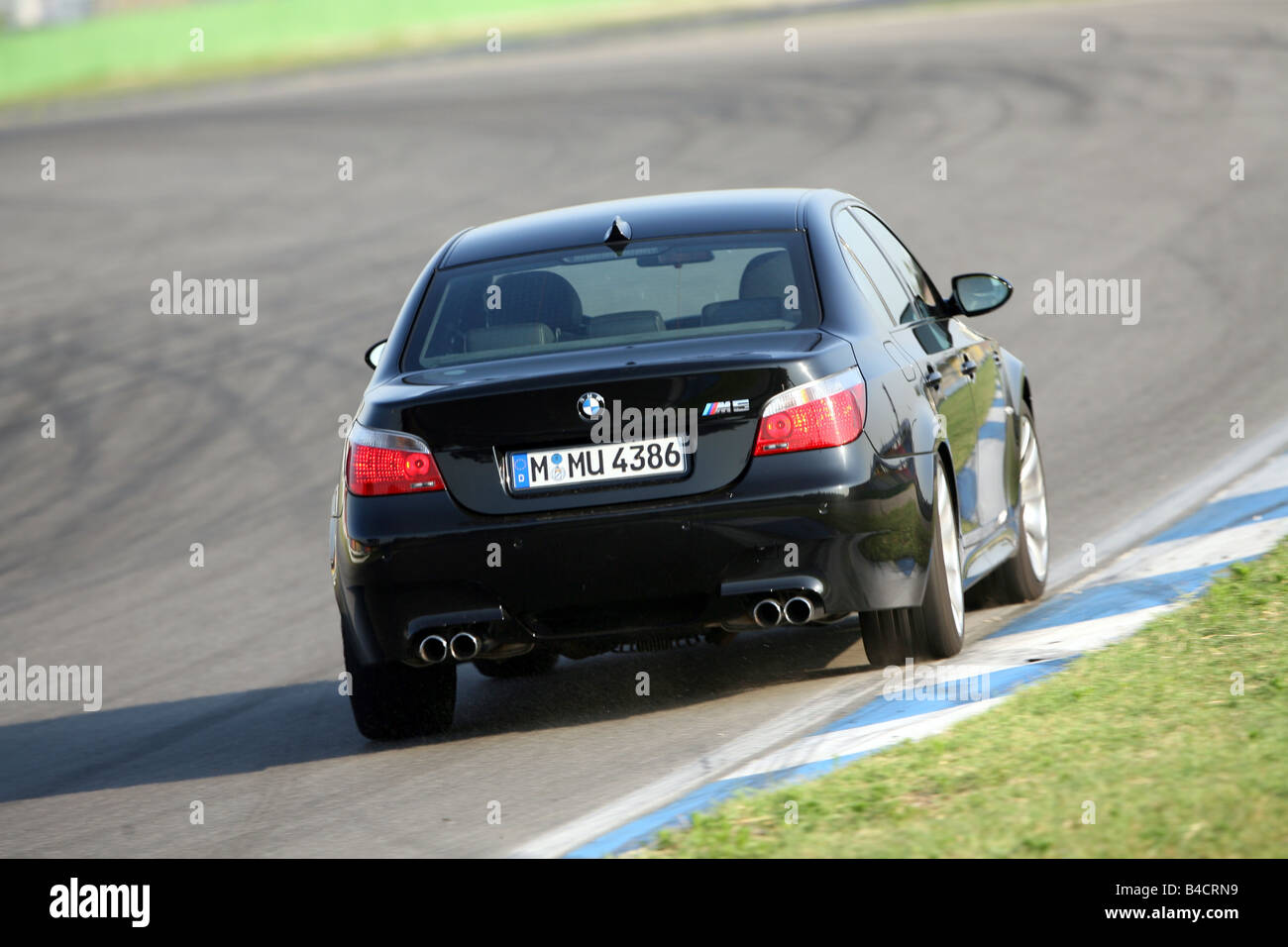 BMW M5, model year 2005-, black, driving, diagonal from the back, rear  view, test track Stock Photo - Alamy