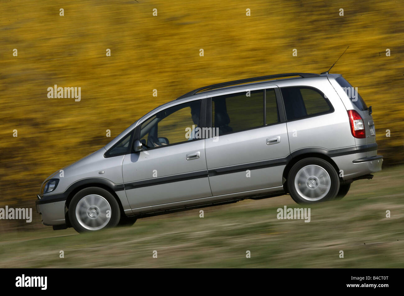 Car, Opel Zafira 2.2 DTI, model year 2003-, silver, Van, driving, side view, country road Stock Photo