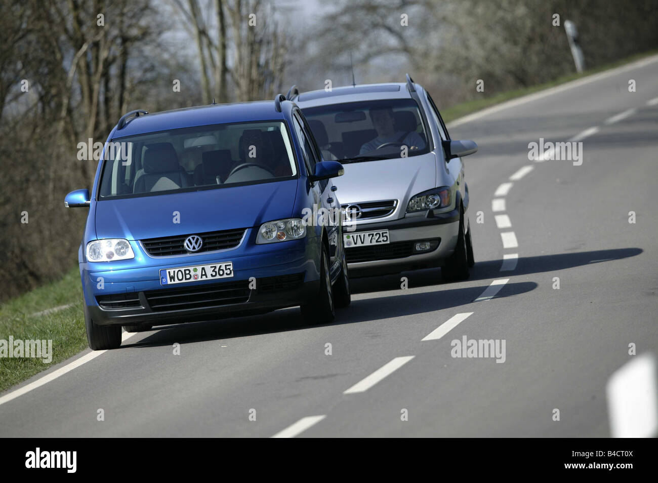 Car, Opel Zafira 2.2 DTI, model year 2003-, silver, Van, VW Volkswagen Touran TDI, Year of construction 2003-, blue, Overtaking Stock Photo