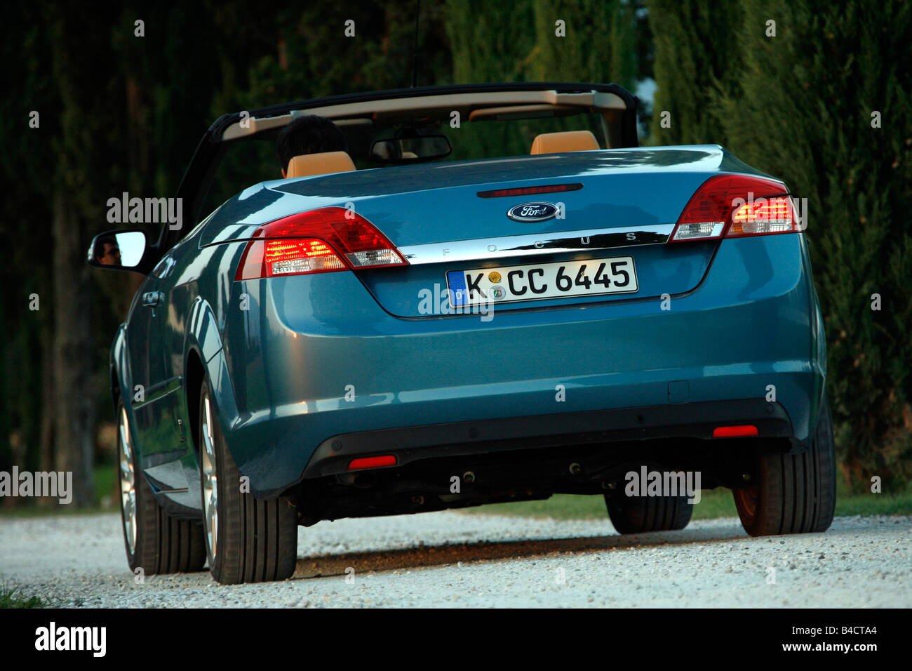 Ford Focus Coupe-Convertible 2.0, model year 2006-, standing, upholding, diagonal from the back, rear view, country road, open t Stock Photo