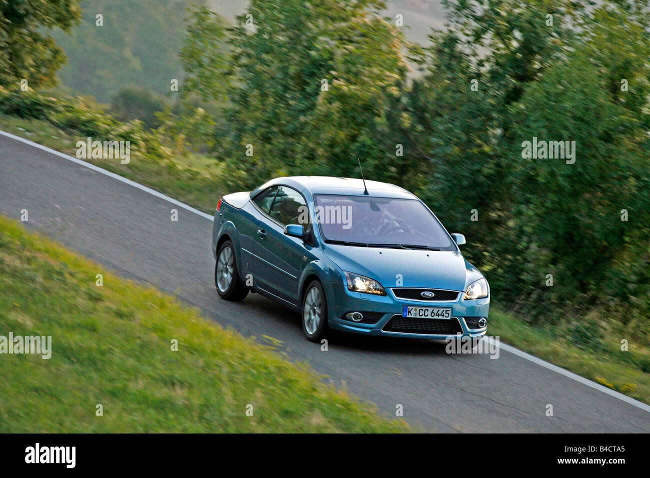 Ford Focus Coupe-Convertible 2.0, model year 2006-, driving, diagonal from the front, frontal view, country road, closed top Stock Photo