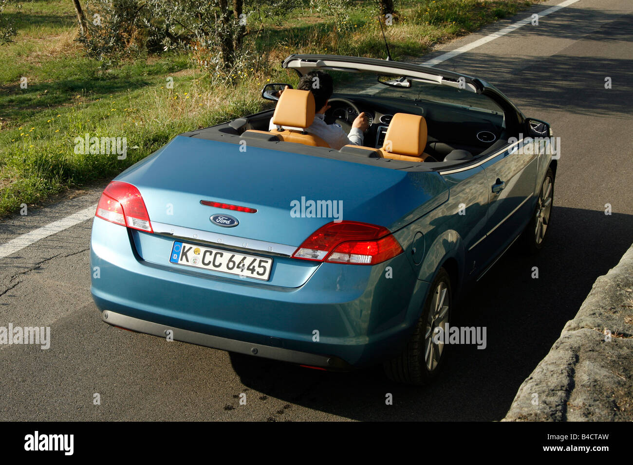 Ford Focus Coupe-Convertible 2.0, model year 2006-, driving, diagonal from the back, rear view, country road, open top Stock Photo