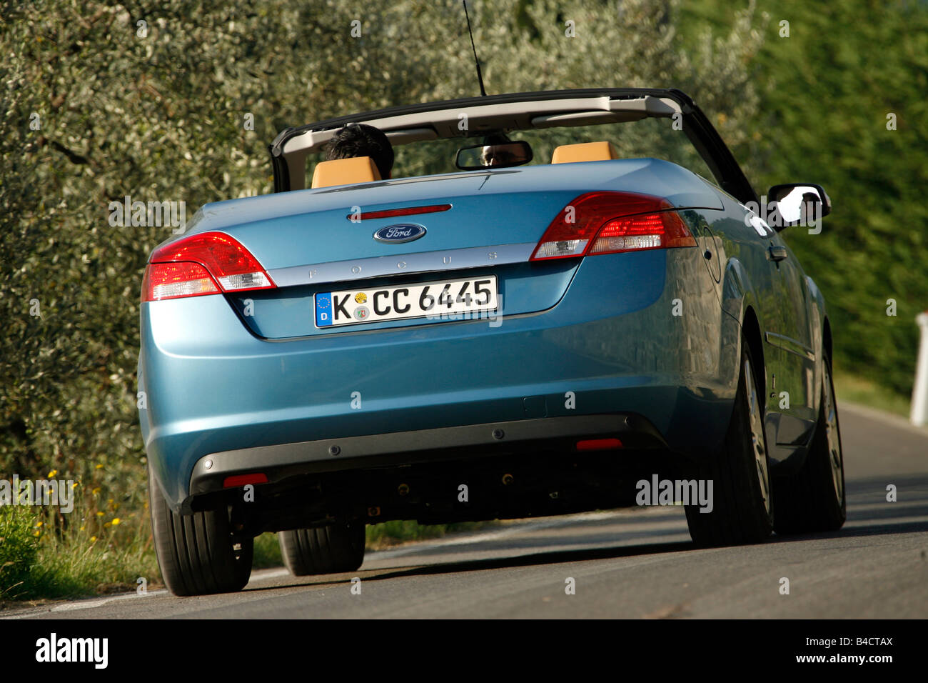 Ford Focus Coupe-Convertible 2.0, model year 2006-, driving, diagonal from the back, rear view, country road, open top Stock Photo