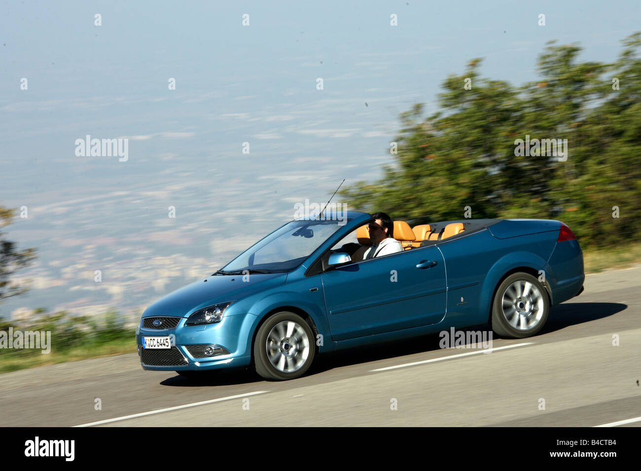 Ford Focus Coupe-Convertible 2.0, model year 2006-, driving, diagonal from the front, side view, country road, open top Stock Photo