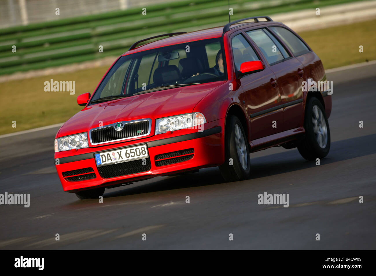Car, Skoda Octavia RS, hatchback, Lower middle-sized class, model year 2000-, red, driving, test track, diagonal from the front, Stock Photo