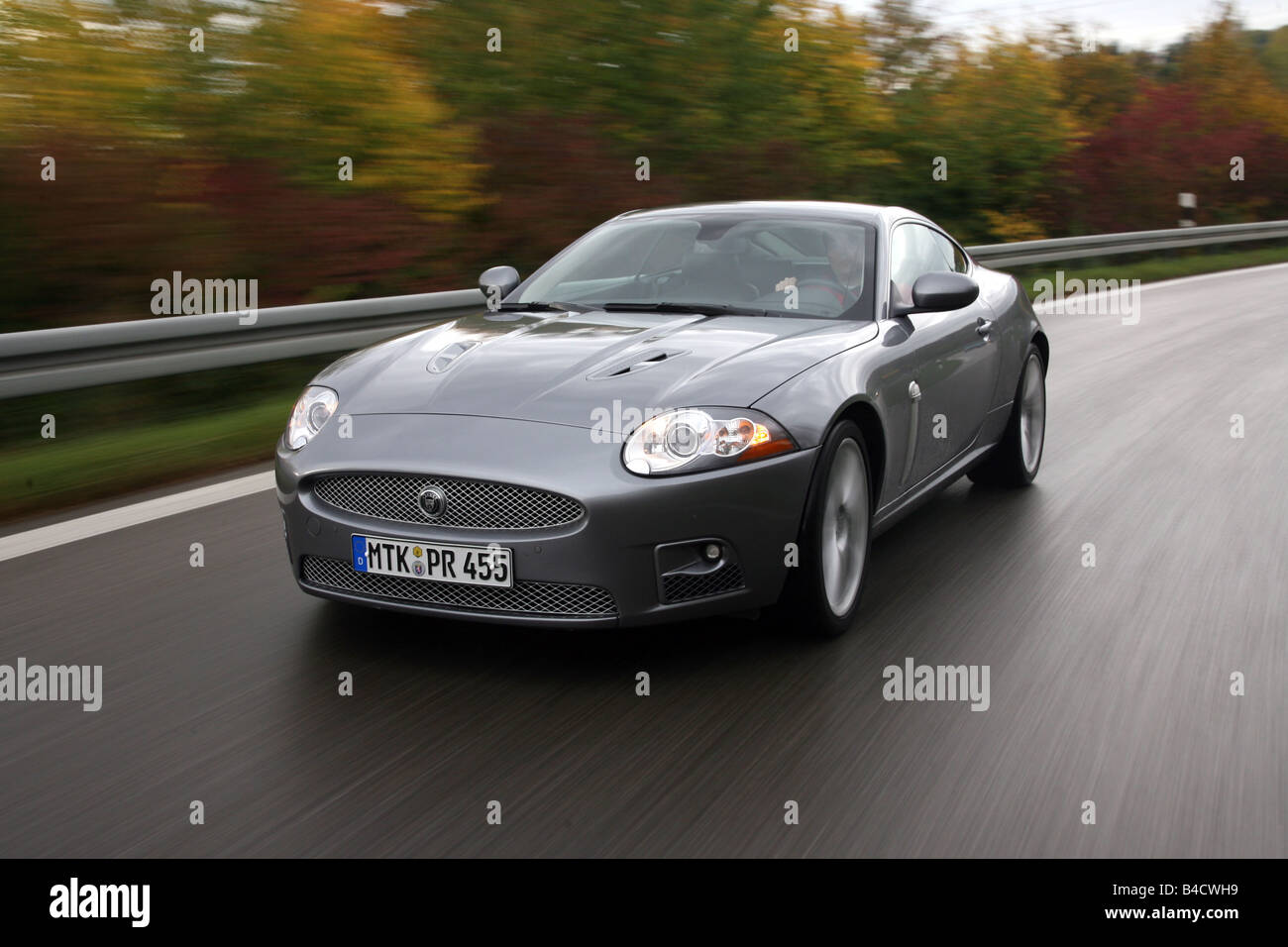 Jaguar XKR coupe, model year 2006-, anthracite, driving, diagonal from the front, frontal view, country road Stock Photo