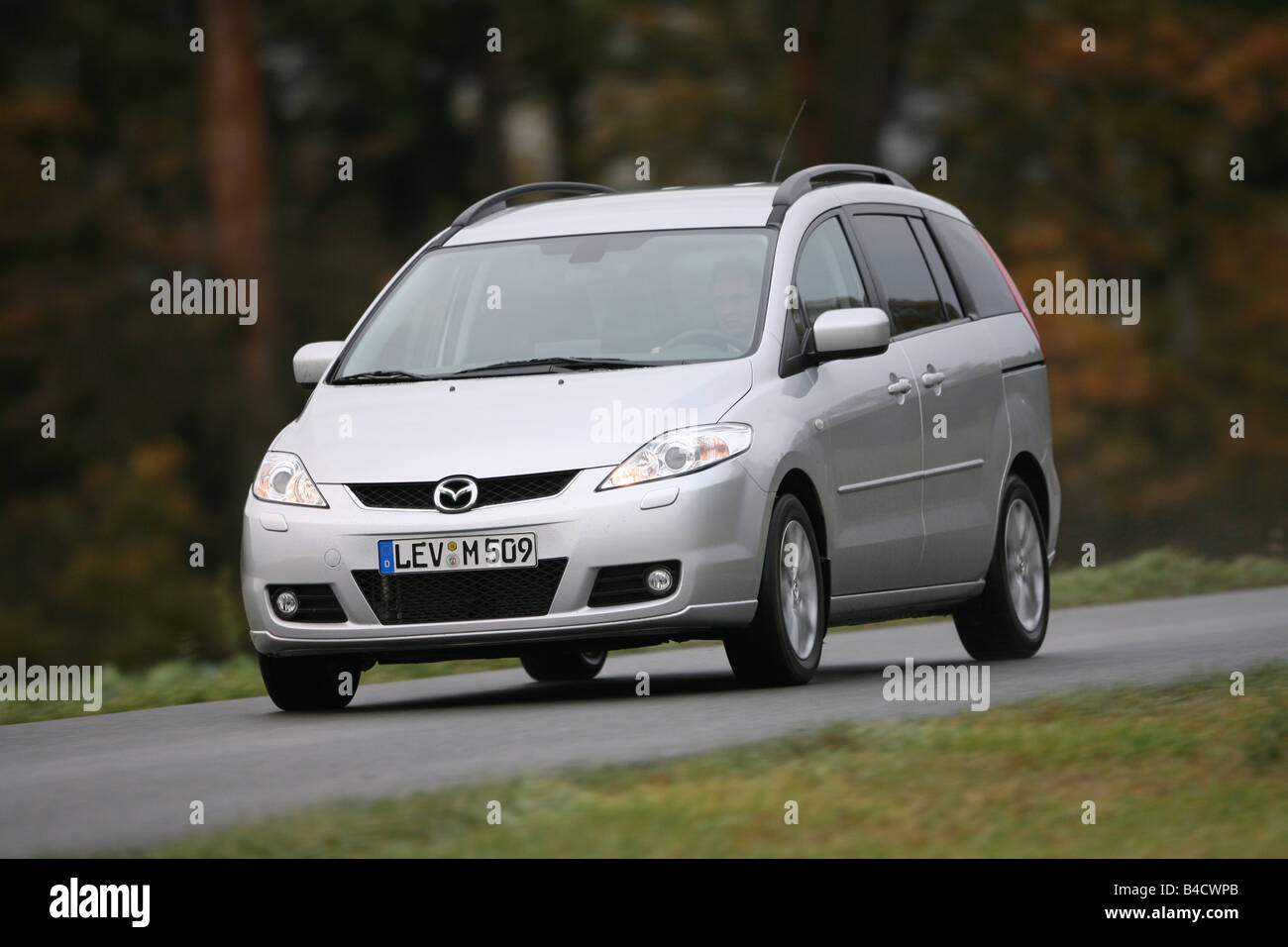 Mazda 5 2.0 MZR Top, silver, model year 2005-, driving, diagonal from the front, frontal view, country road Stock Photo