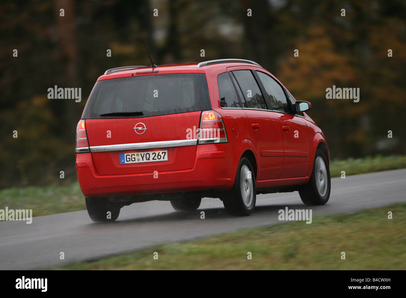 Opel Zafira 1.8 Edition, red, model year 2005-, driving, diagonal from the back, rear view, country road Stock Photo