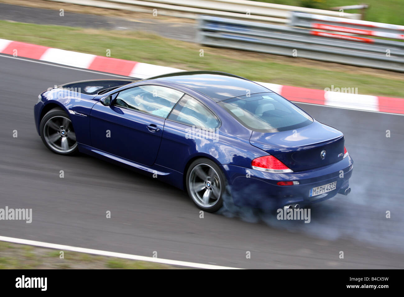 BMW M6, model year 2005-, blue moving, diagonal from the back, side ... BMW M6, model year 2005-, blue moving, diagonal from the back, side ...