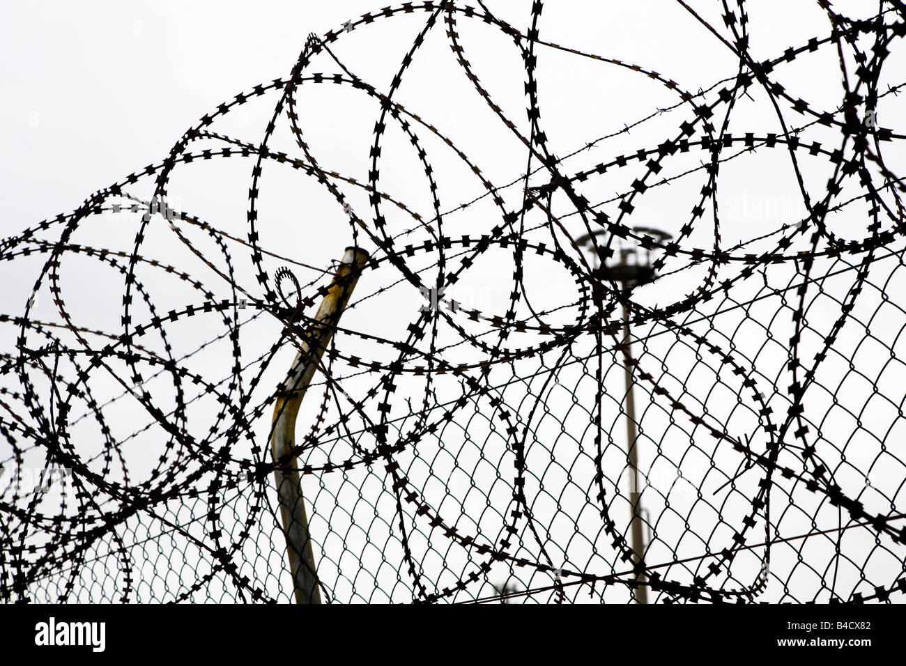 Razor wire and fence silhouette UK Stock Photo