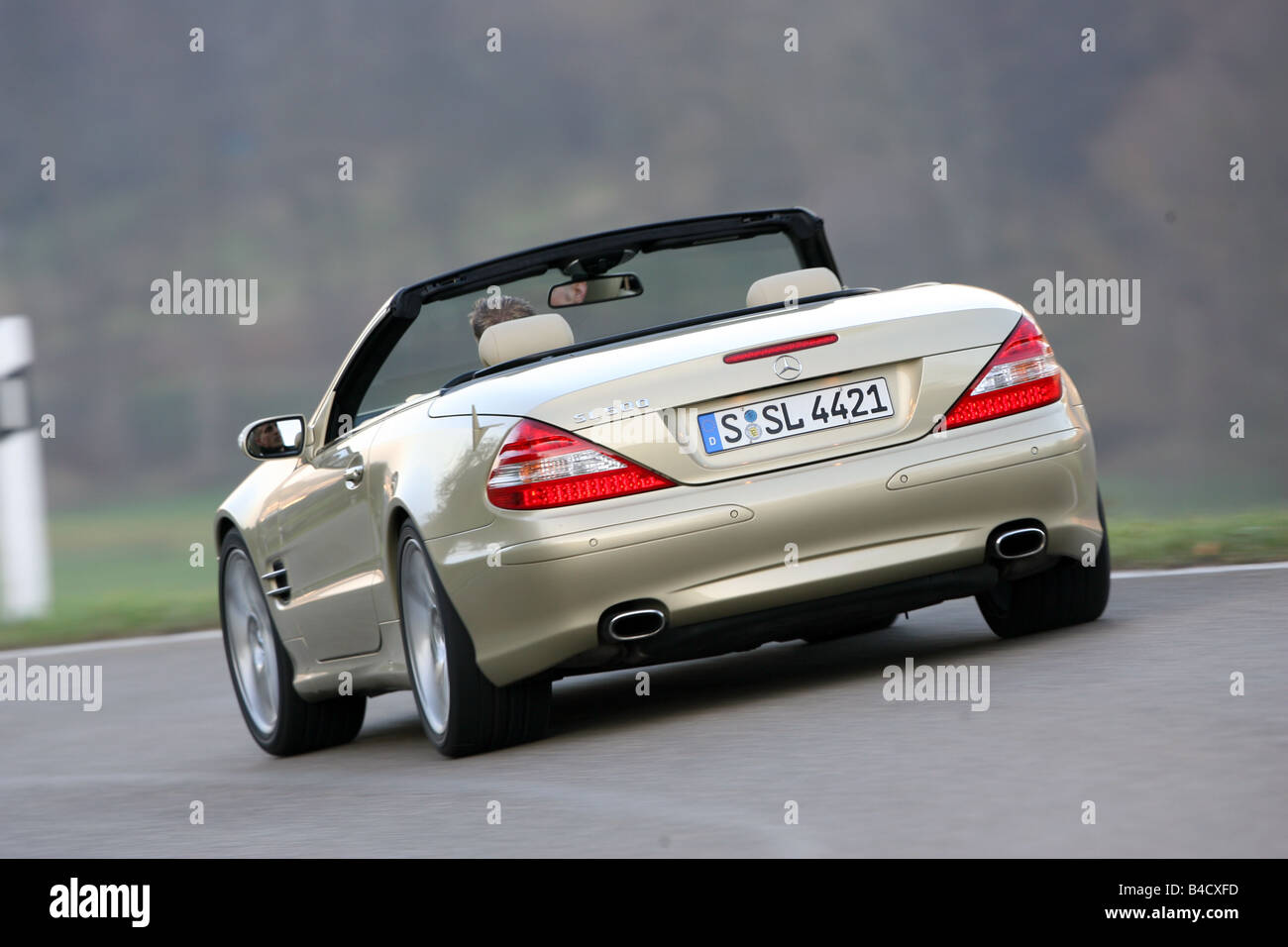 Mercedes Sl 500 Model Year 2005 Gold Driving Diagonal From The Back Rear View Country Road Open Top Stock Photo Alamy
